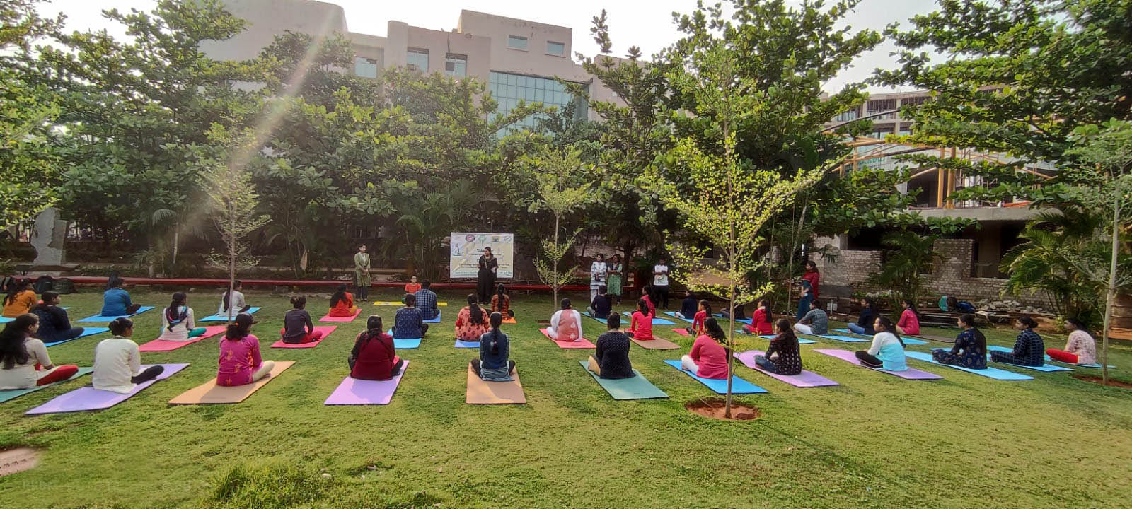 Students practising yoga on the KIIT campus lawn